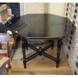 A late Victorian James Shoolbred ebonised octagonal table,