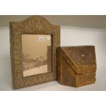 A tooled leather stationery box, decorated a crown, 26 cm wide, and a strutt mirror,