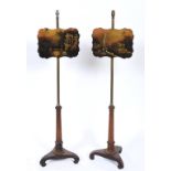 A pair of early Victorian rosewood pole screens,