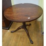 A mahogany tripod table, on a birdcage support, 64.