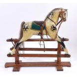 A dapple grey painted rocking horse, on a pine stand,