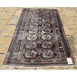 An Afghan rug, with gold motifs on a black ground, Ghul,