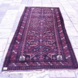 EXTRA LOT: A Turkoman rug, decorated geometric motifs on a black ground, within a multi border,