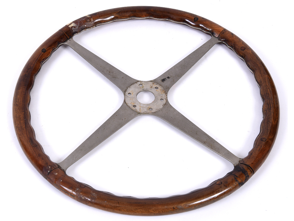 An original Bugatti Type 57 wood rim and four spoke aluminium steering wheel,