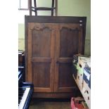 A Continental walnut two door wardrobe, 111 cm wide,