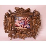 A brass frame, decorated cherubs, 18 cm