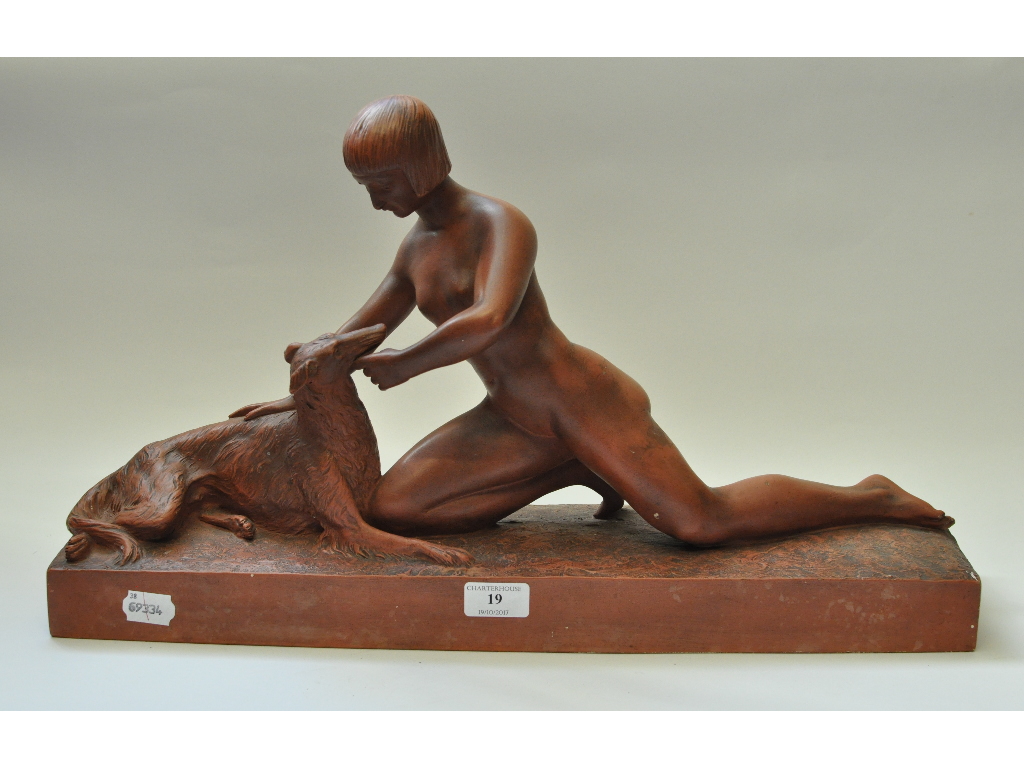 An Art Deco terracotta group after Herman Heusers, of a nude female with a lurcher,
