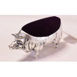 A silver plated pig pincushion,