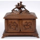 A Black Forest carved wood cigar box, the lid surmounted a pair of pheasants,