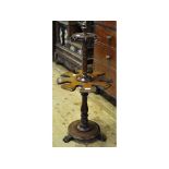 A Victorian mahogany whip and boot stand, on a turned column, platform base and three paw feet,