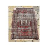 A Caucasian rug, decorated geometric motifs on a red ground within a multi border,