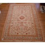 A Persian carpet, with stylised motifs on a cream ground, within a multi border,