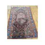 A Persian Malayer rug, decorated stylised floral motifs on a blue ground,