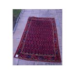 A Persian rug, with a boteh design,