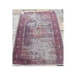 A Persian Afshar rug with floral motifs on a blue ground,