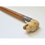 A walking cane, having a carved ivory handle in the form of an otter's head,