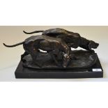 A pair of bronze hound dogs, on a scent, on a marble base,