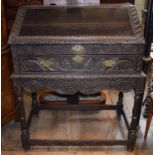 A carved oak clerk's desk, on a stand,