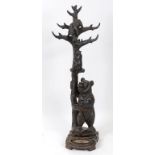 A late 19th/early 20th century Black Forest style carved bear hat/stick stand,