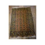 An Afghan rug, with stylised floral motifs, on an orange/brown ground,