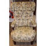 A pair of button back upholstered wing armchairs,