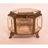 A gilt metal and glass display case, of hexagonal form, 8 cm wide,