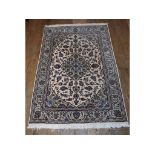 A Persian medallion rug, with floral motif on a white ground, within a multi border,