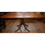 An early 19th century mahogany breakfast table, on a turned column and four receded downswept legs,