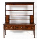 A 19th century oak dresser, the three tier plate rack having a pair of panel doors,