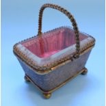 A gilt metal and glass display case, in the form of a basket, 8 cm high,