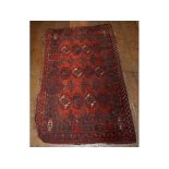 A Turkoman Juval rug, with geometric motifs on a red ground, within a multi border,