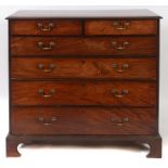 A George III mahogany chest, of two short and four graduated long drawers, on bracket feet,