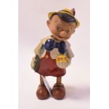 A clockwork composition Pinocchio, 19 cm high, and a late Victorian rugby cap, 1893-4,