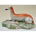 A Staffordshire pottery greyhound, with hare,