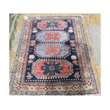 A Caucasian rug, with geometric motifs on a blue ground, within a multi border,