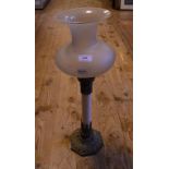 An oil lamp, on a brass base with an opaque glass column and a frosted glass shade,