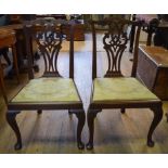 A pair of George III walnut dining chairs, with pierced vase shaped splats,