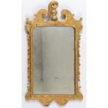 A George II style carved giltwood mirror, with an acanthus leaf finial,