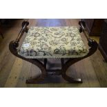 A 19th century rosewood and simulated rosewood X frame stool, with floral upholstery,