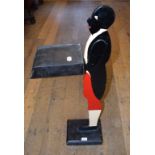A painted dumb waiter, in the form of a butler,