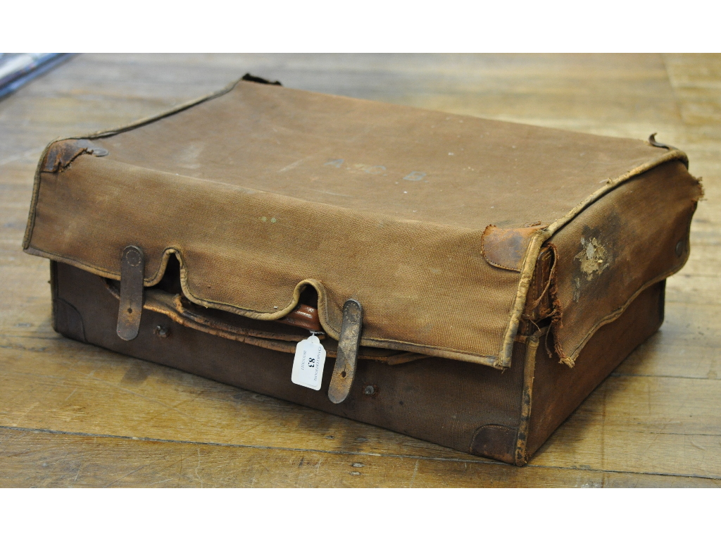 A Drew & Sons leather suitcase, initialled, in its canvas protective case,