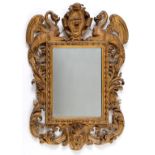 An Italian carved giltwood frame, inset a mirror,