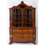 A Dutch walnut bombe cabinet on chest, inlaid with beasts, scrolling acanthus leaves,