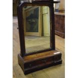 A late 19th century walnut dressing mirror, the box base with three drawers,