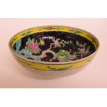 A Chinese famille noir bowl, decorated a bird, flowers and foliage, 24.