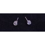 A pair of diamond stud earrings