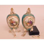 A pair of Berlin porcelain vases and covers, each painted two panels of figures,