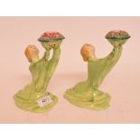 A pair of Clarice Cliff Lady candlesticks, with blonde hair and a green dress,