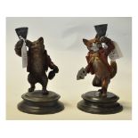 A painted metal fox candlestick, with a matching bear candlestick, on circular bases,