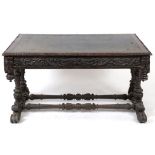 A late Victorian Anglo-Flemish oak writing table, having a leather inset top,